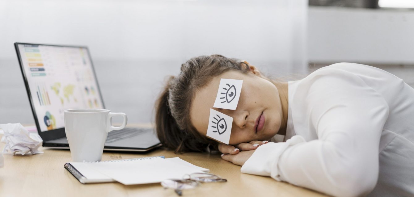 tired-businesswoman-covering-her-eyes-with-drawn-eyes-paper tired-businesswoman-covering-her-eyes-with-drawn-eyes-paper