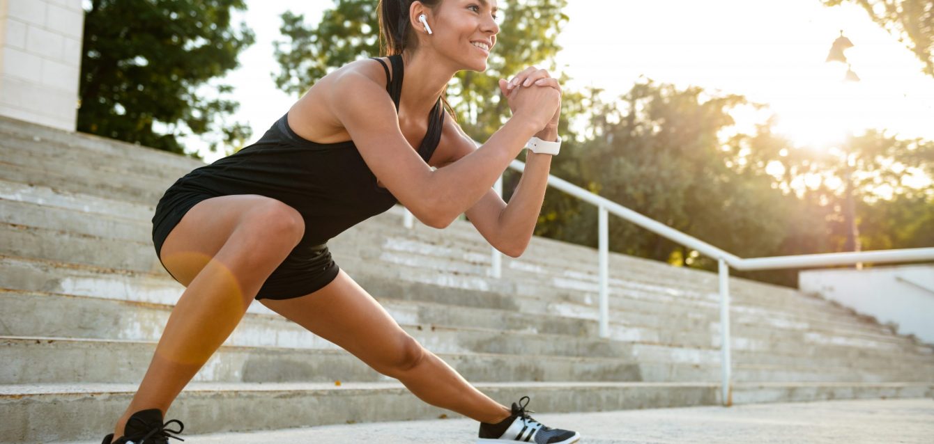 Portrait of a smiling fitness woman in earphones Portrait of a smiling fitness woman in earphones