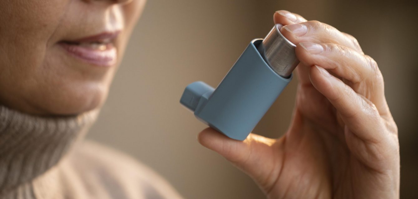 senior-woman-holding-asthma-inhaler
