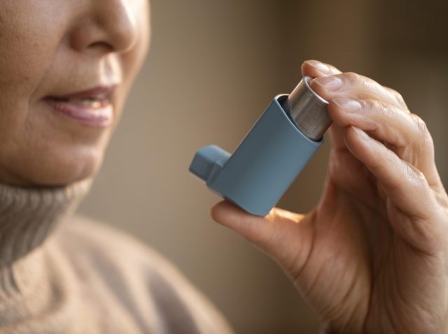 senior-woman-holding-asthma-inhaler