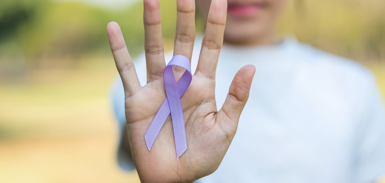 World cancer day (February 4). Woman hand holding Lavender purpl World cancer day (February 4). Woman hand holding Lavender purpl