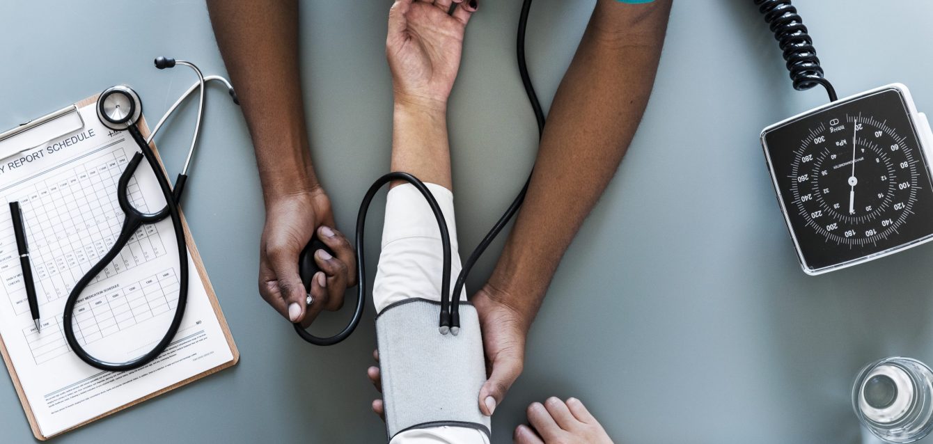 Nurse measuring patient blood pressure