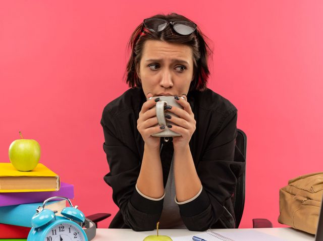 Worries and Anxious Student Drinks Cup of Coffee