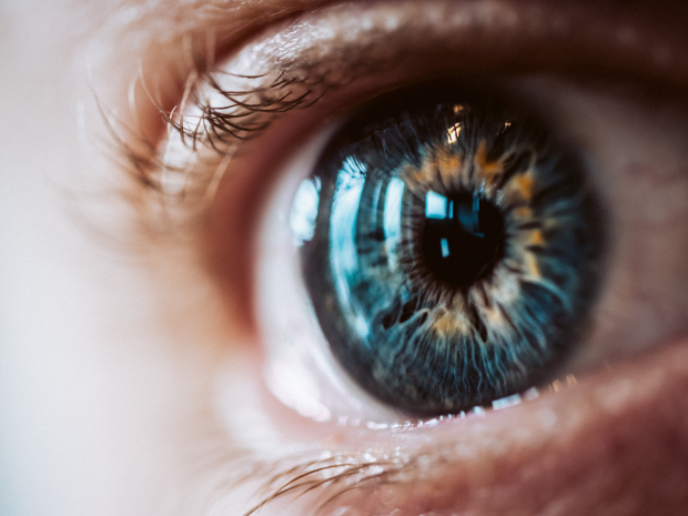 An extreme closeup of an enlarged human eye with beautiful colors