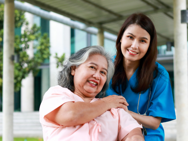 Asian female doctor treats an elderly patient sitting in a wheelchair. Concept of medical services in hospitals. surgical treatment of patients